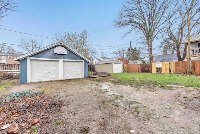 detached garage featuring fence