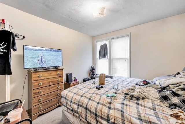 bedroom featuring light carpet