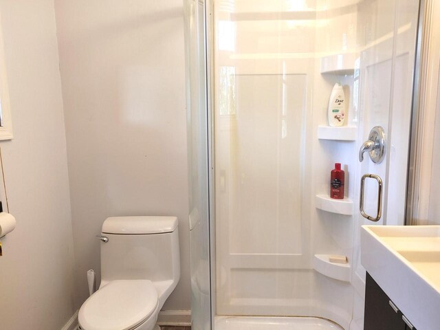 416 Waldeck Dr, Twin Lakes, WI 53181 - full bath featuring vanity, a stall shower, and toilet