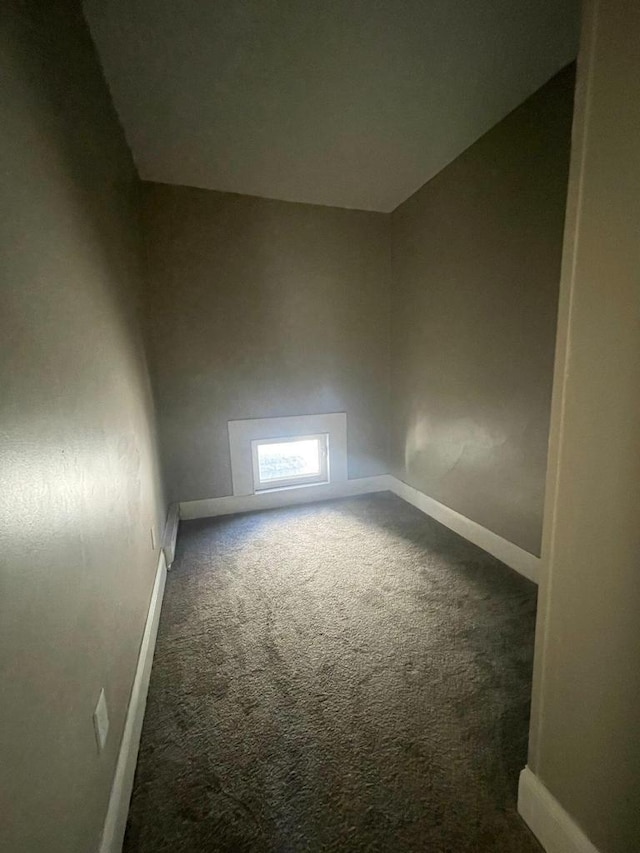 carpeted spare room with baseboards