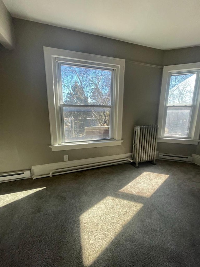 empty room featuring carpet floors, a baseboard radiator, radiator heating unit, and a healthy amount of sunlight