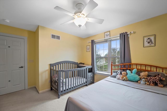 bedroom with light colored carpet, baseboards, visible vents, and a ceiling fan