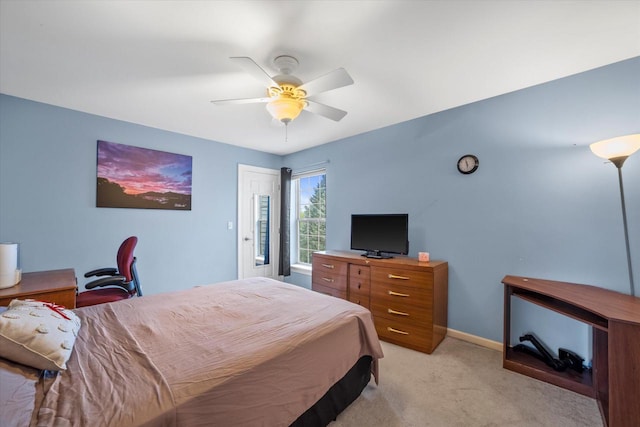 bedroom with light colored carpet, a ceiling fan, and baseboards