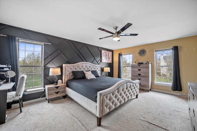 carpeted bedroom featuring baseboards and ceiling fan