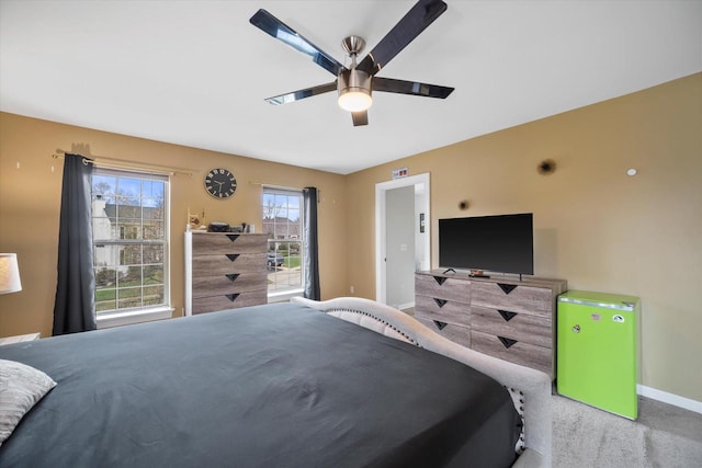 bedroom featuring baseboards, ceiling fan, and carpet