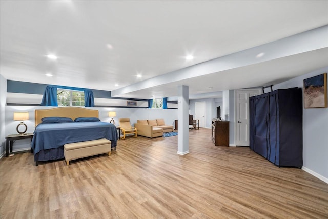 bedroom with recessed lighting, baseboards, and light wood-type flooring
