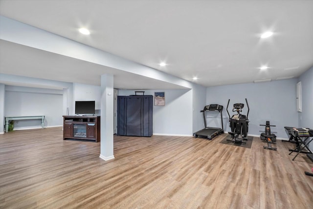 workout room featuring recessed lighting, baseboards, and wood finished floors