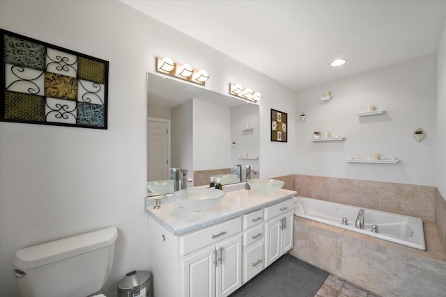 full bathroom with a garden tub, a sink, double vanity, and toilet