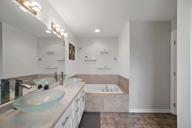 full bath with double vanity, a sink, and a garden tub