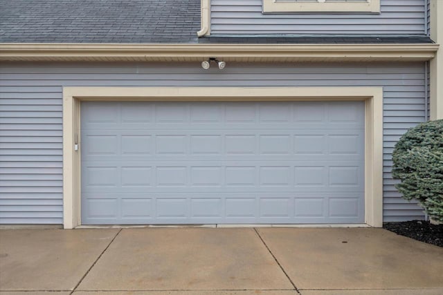 garage featuring concrete driveway