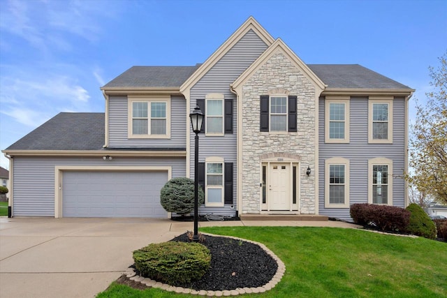 view of front of home featuring a front yard, driveway, and stone siding