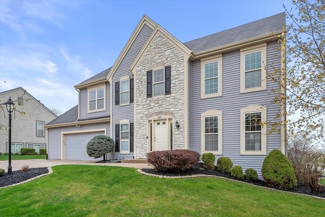view of front facade with a garage, driveway, a front lawn, and stone siding