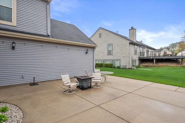 view of patio with a fire pit and a deck