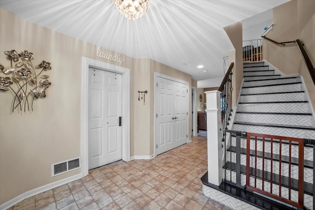 foyer with recessed lighting, baseboards, stone finish flooring, visible vents, and stairway