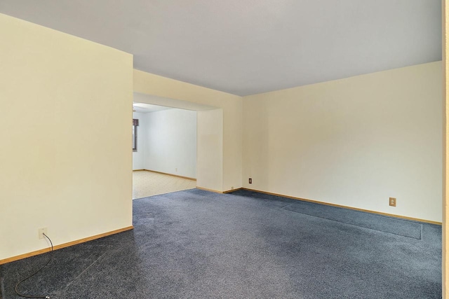 empty room with baseboards and carpet floors