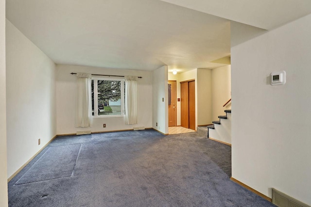 unfurnished living room featuring stairway, baseboards, carpet flooring, and visible vents
