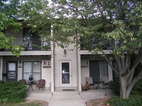 back of property featuring a patio and a balcony