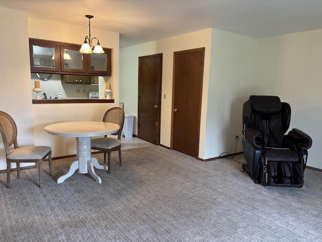 carpeted dining room with baseboards