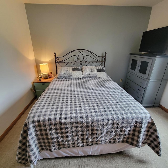 bedroom featuring baseboards and carpet flooring