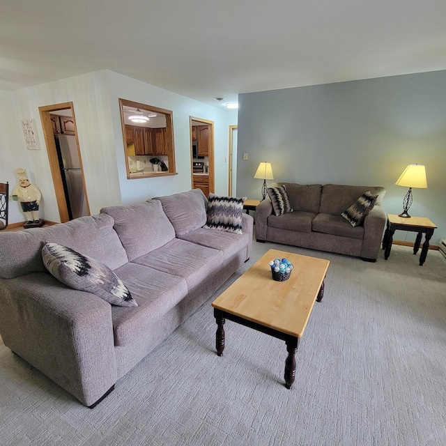 living area featuring baseboards and carpet