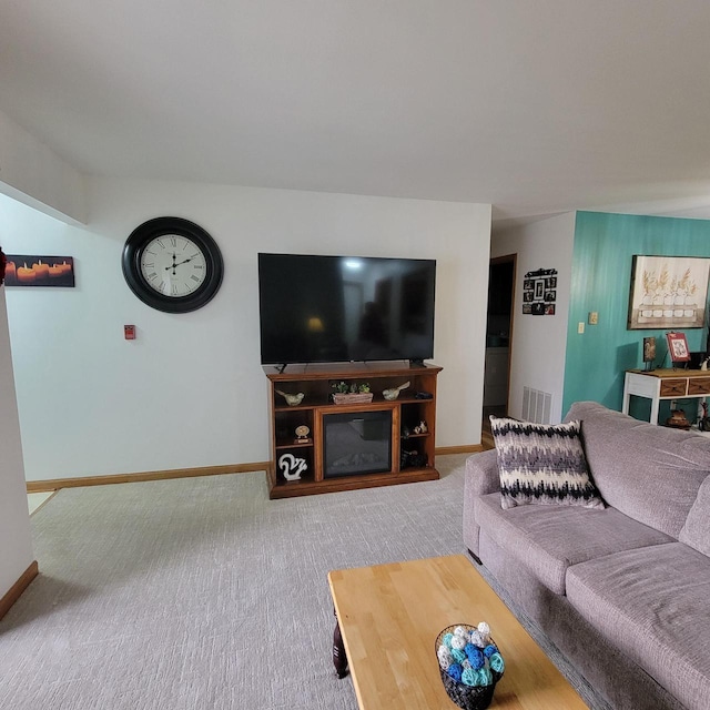 living room featuring carpet flooring, baseboards, and visible vents