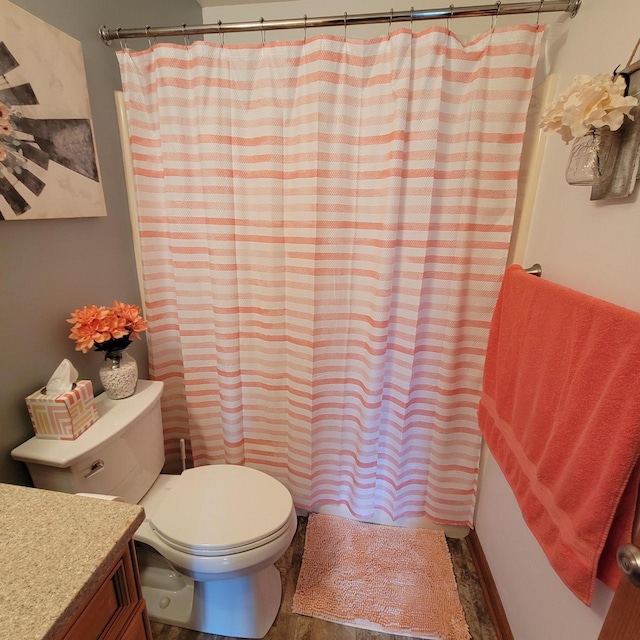 full bath featuring toilet, shower / bath combo, and vanity