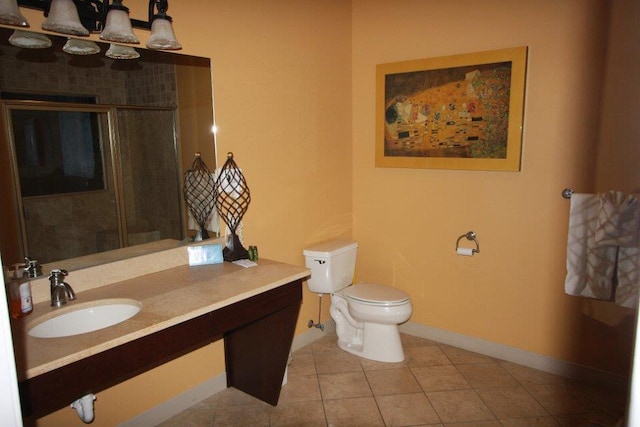 full bathroom with tile patterned flooring, vanity, toilet, baseboards, and a shower with shower door
