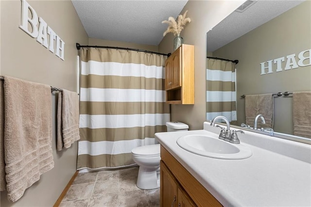 bathroom featuring a textured ceiling, visible vents, vanity, toilet, and a shower with shower curtain