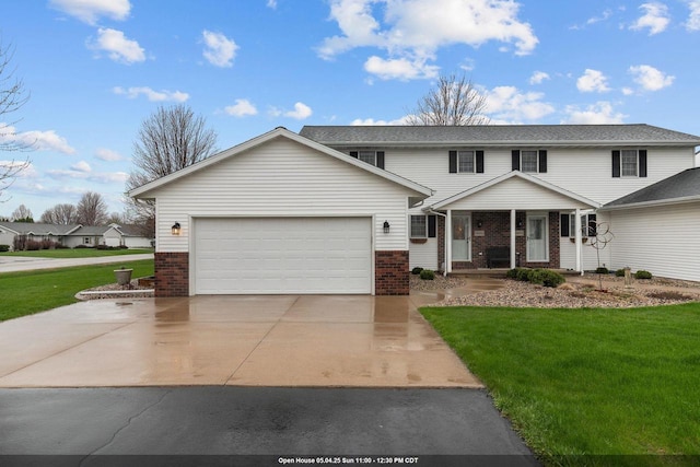 traditional home with a garage, concrete driveway, a front yard, and brick siding