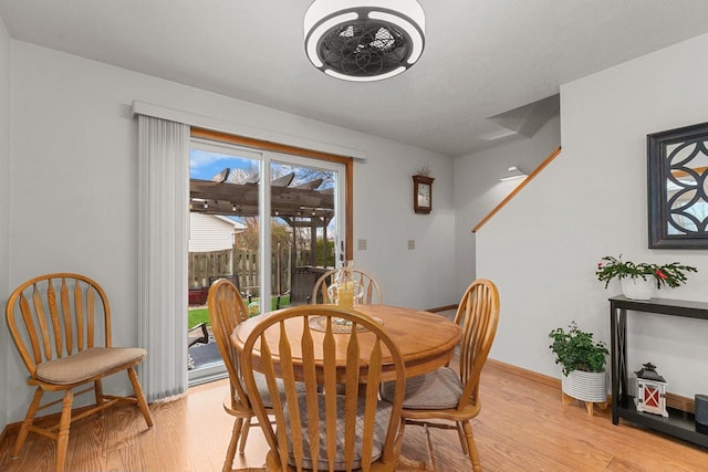 dining room with light wood-type flooring and baseboards