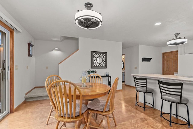 dining room with recessed lighting, baseboards, and light wood-style floors