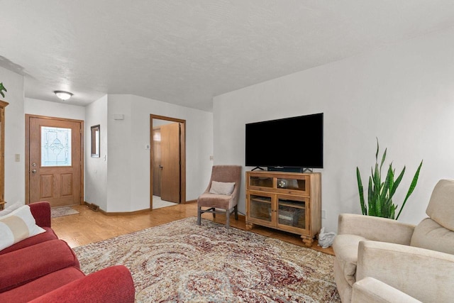 living room featuring baseboards and wood finished floors