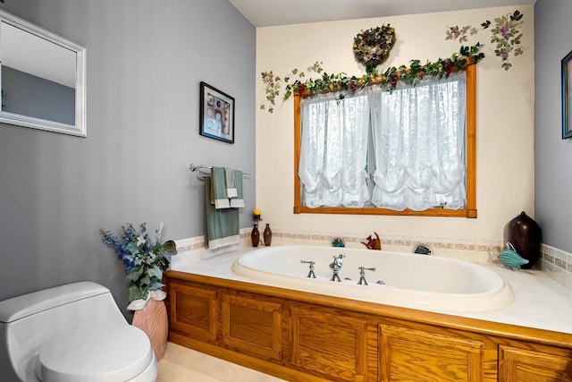 full bath featuring a garden tub and toilet