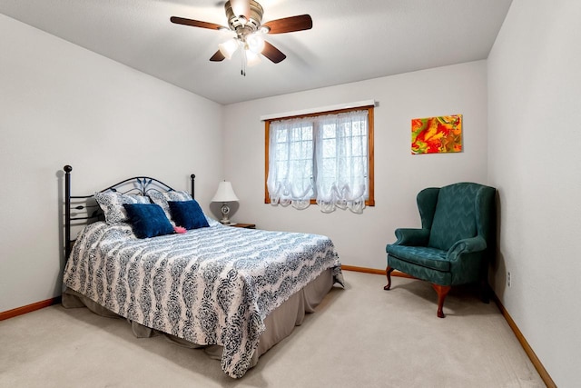 bedroom featuring a ceiling fan, baseboards, and light colored carpet