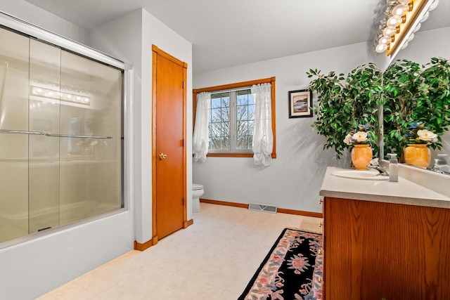 full bath featuring visible vents, vanity, toilet, baseboards, and tile patterned floors