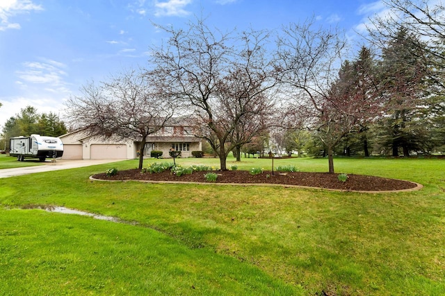 view of front facade with a garage, a front lawn, and driveway