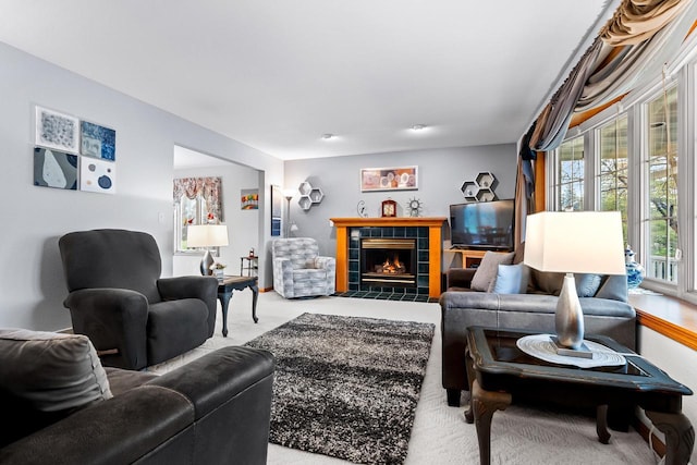 living room with a tile fireplace