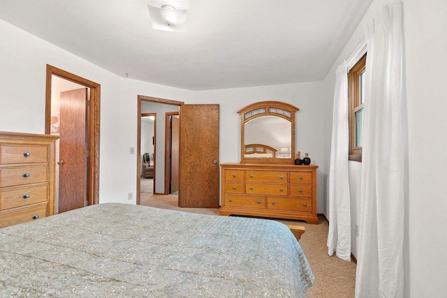bedroom featuring light carpet