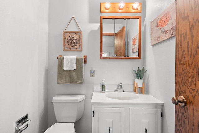 half bathroom with vanity and toilet