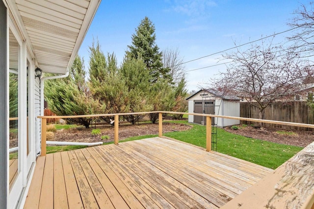 wooden terrace featuring a storage shed, a yard, an outdoor structure, and a fenced backyard