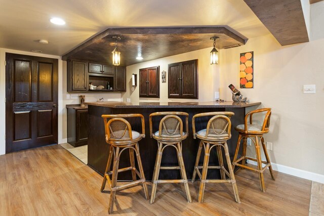 1755 Carmen Ave, Sheboygan, WI 53081 - bar featuring baseboards, wet bar, light wood finished floors, and decorative light fixtures