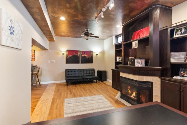 1755 Carmen Ave, Sheboygan, WI 53081 - living area featuring baseboards, ceiling fan, a fireplace, and wood finished floors