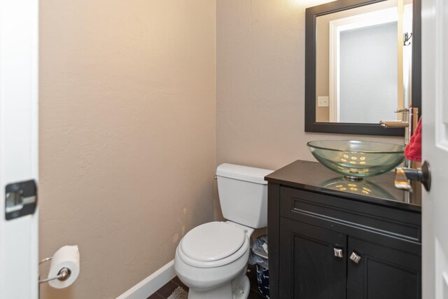 1755 Carmen Ave, Sheboygan, WI 53081 - bathroom featuring toilet, baseboards, and vanity