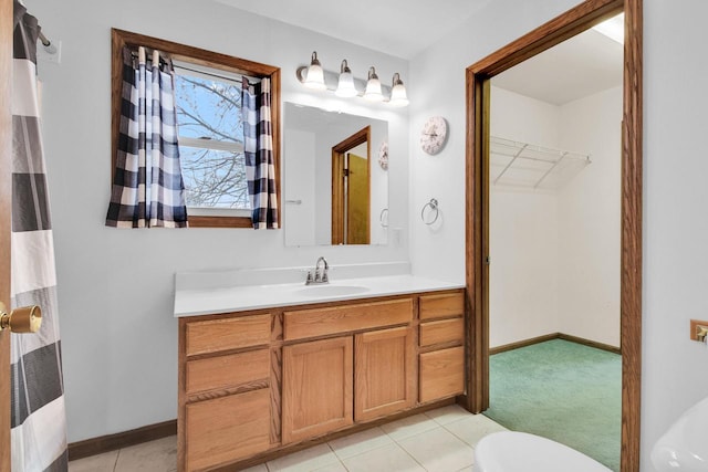 3317 E Denton Ave, Saint Francis, WI 53235 - bathroom featuring vanity, tile patterned floors, a spacious closet, baseboards, and toilet