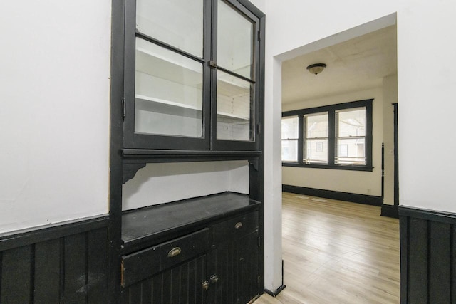 hallway featuring wainscoting and light wood finished floors