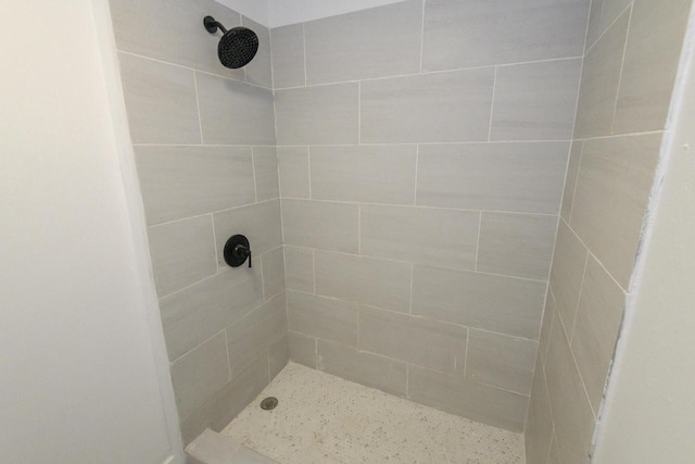 bathroom with tiled shower