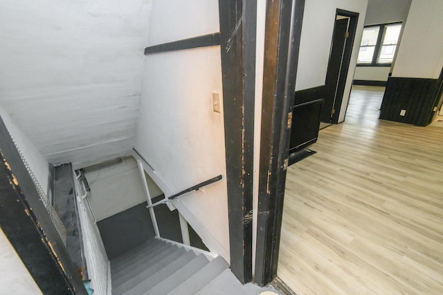 stairway featuring wood finished floors