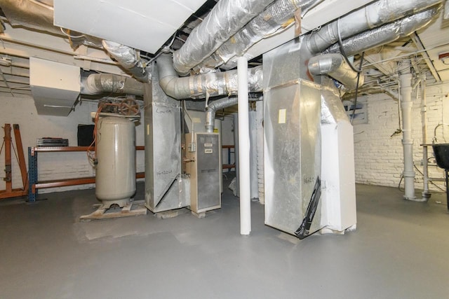 unfinished below grade area featuring heating unit and gas water heater