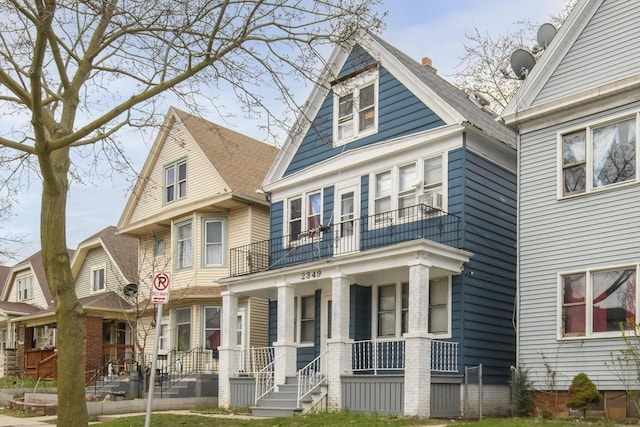 view of front facade featuring covered porch and a balcony