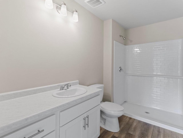 W194N16740 Eagle Dr Unit 1, Jackson, WI 53037 - bathroom featuring vanity, a shower, and wood finished floors